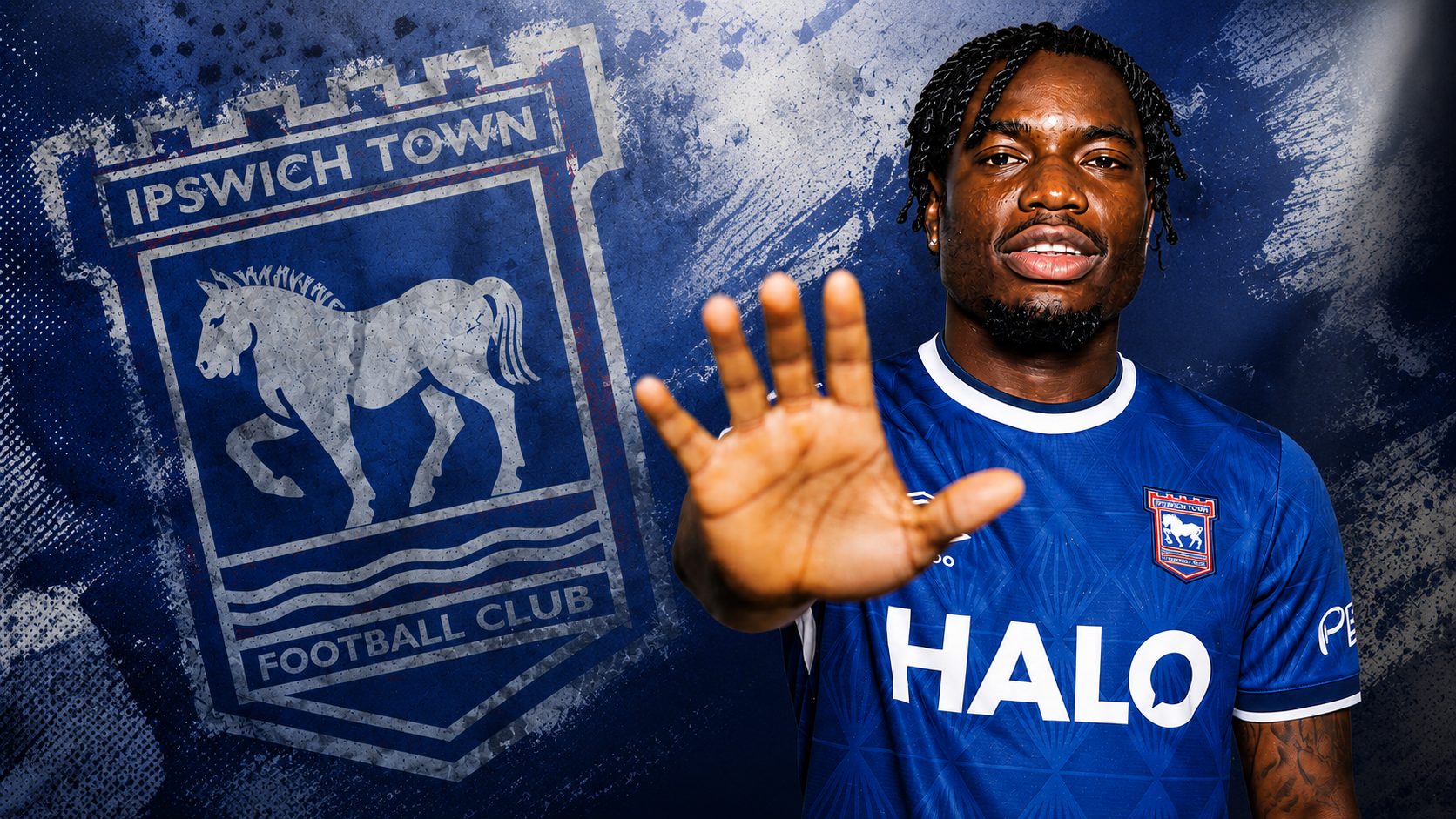 Abdul Fatawu poses in an Ipswich Town shirt after completing his transfer