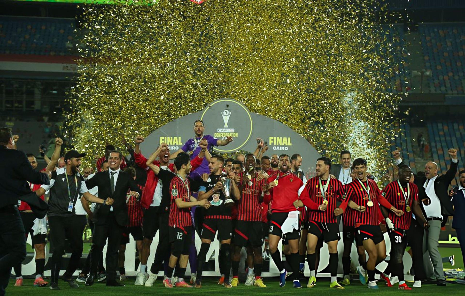 USM Alger players in red and black celebrate winning the CAF Confederation Cup in Cairo