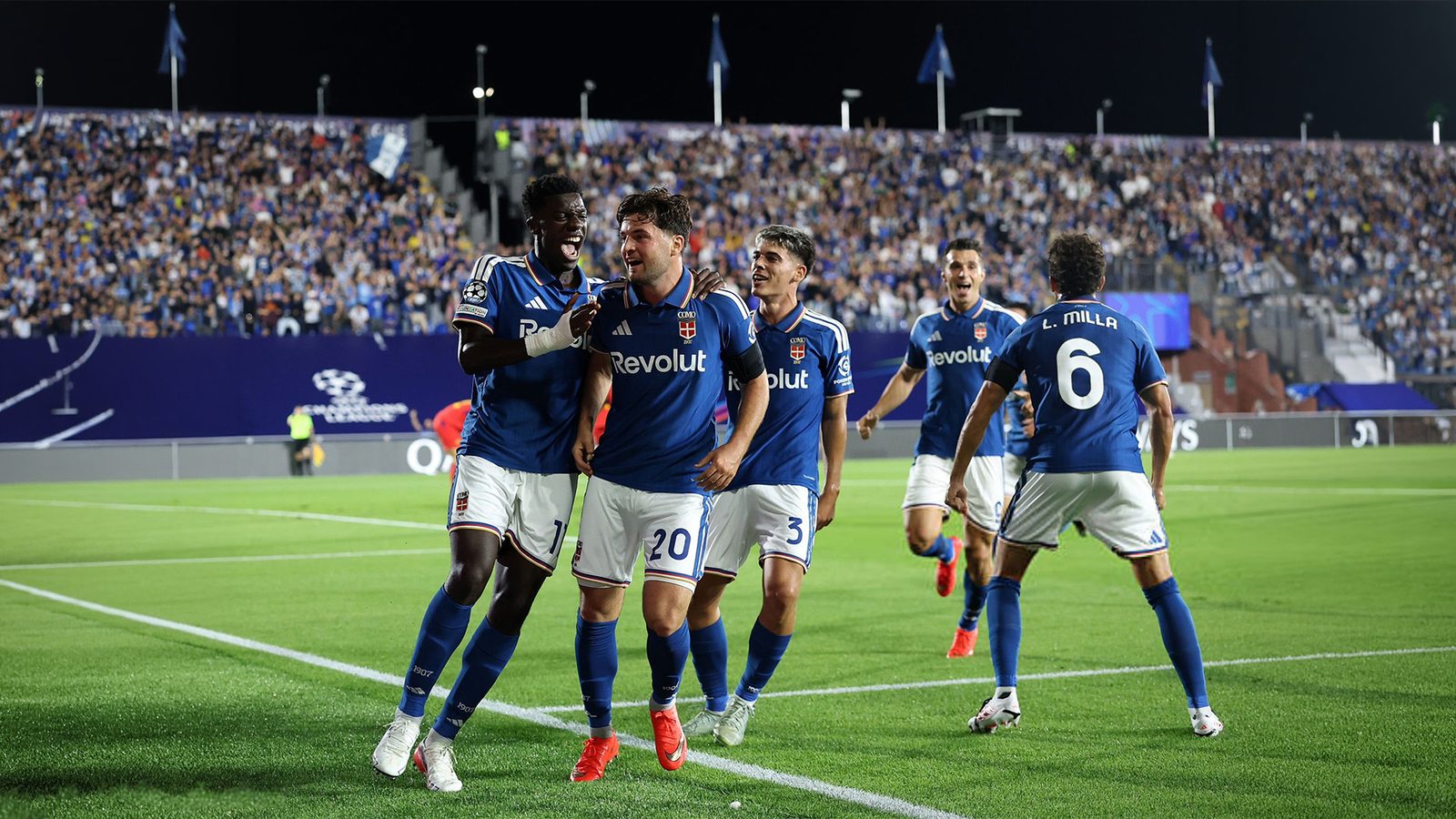 Como players celebrate a goal against RB Leipzig in the Champions League