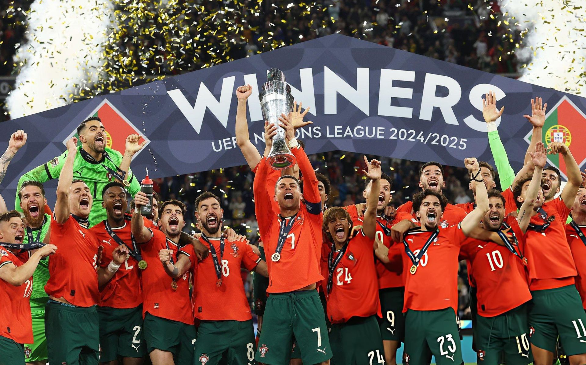 Portugal's players celebrate with the UEFA Nations League trophy after beating Spain in the 2024-25 final